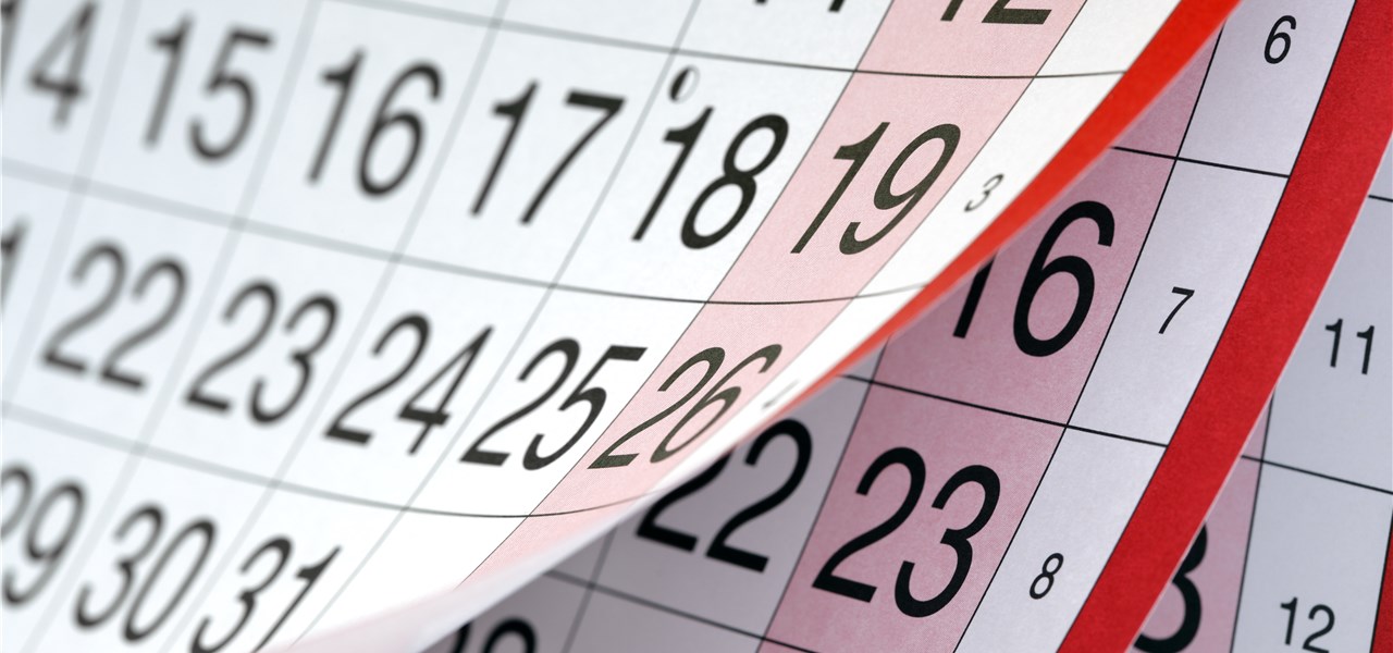 Ein Kalender wird aufgeblättert und zeigt die Wochentage und Kalenderwochen.